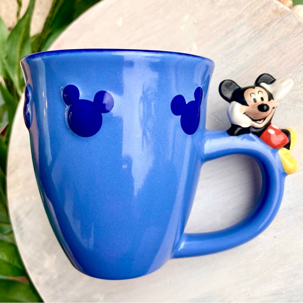 Disney Mickey Mouse mug with Mickey sitting on the handle.Excellent condition